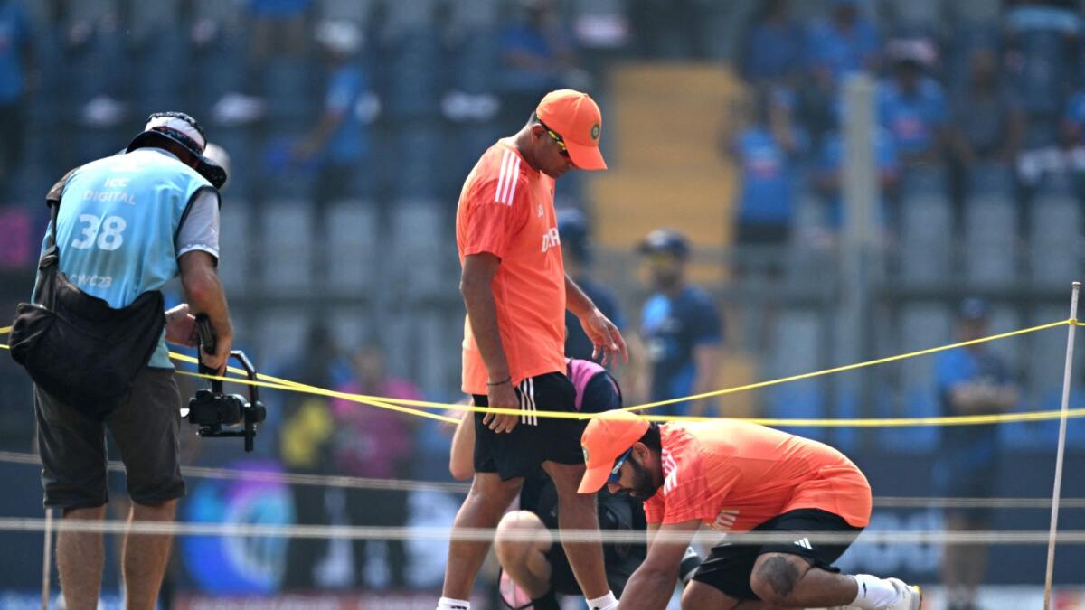 India captain Rohit Sharma (right) and head coach Rahul Dravid inspect the pitch before the start of the World Cup semifinal against New Zealand. — AFP