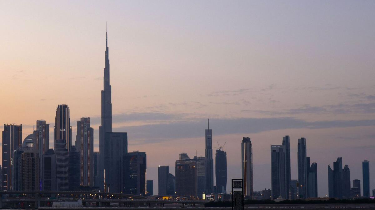 People cycling with a general view of the Dubai skyline including Burj Khalifa. — AFP