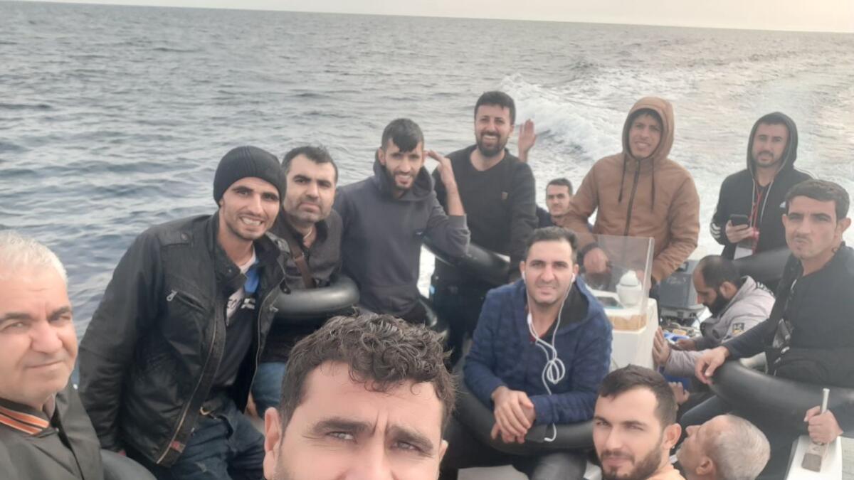 Baran Mesko takes a selfie in a fishing boat with a dozen other Kurdish Syrian migrants before leaving to Spain in Oran, Algeria, on October 15, 2022. — AP
