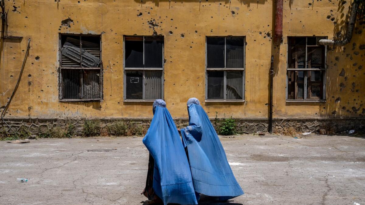 Afghan women wait to receive food rations distributed by a humanitarian aid group, in Kabul, Afghanistan, on May 28, 2023. — AP file