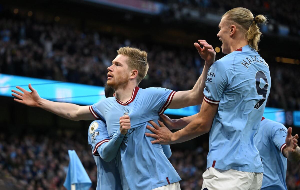 Manchester City's Kevin De Bruyne (left) celebrates scoring the opening goal with Erling Haaland. — AFP