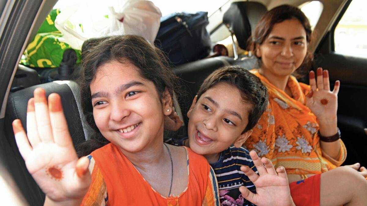 Pakistani nationals, who were previously stranded in India following the closure of borders due to the Covid-19 coronavirus lockdown, wave as they sit inside a car before crossing through the India-Pakistan Wagah border post, some 35 kms from Amritsar, Punjab, India. Photo: AFP