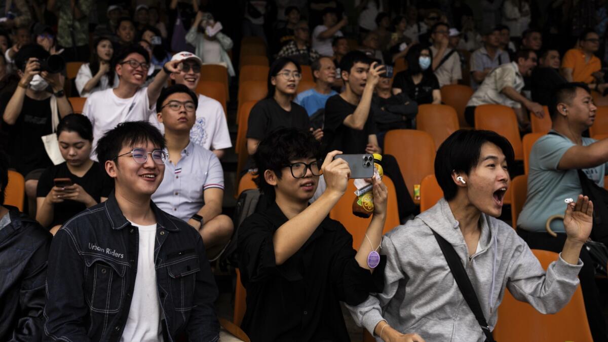 Visitors react as they watch a horse race at the Macao Jockey Club in Macao. — AP