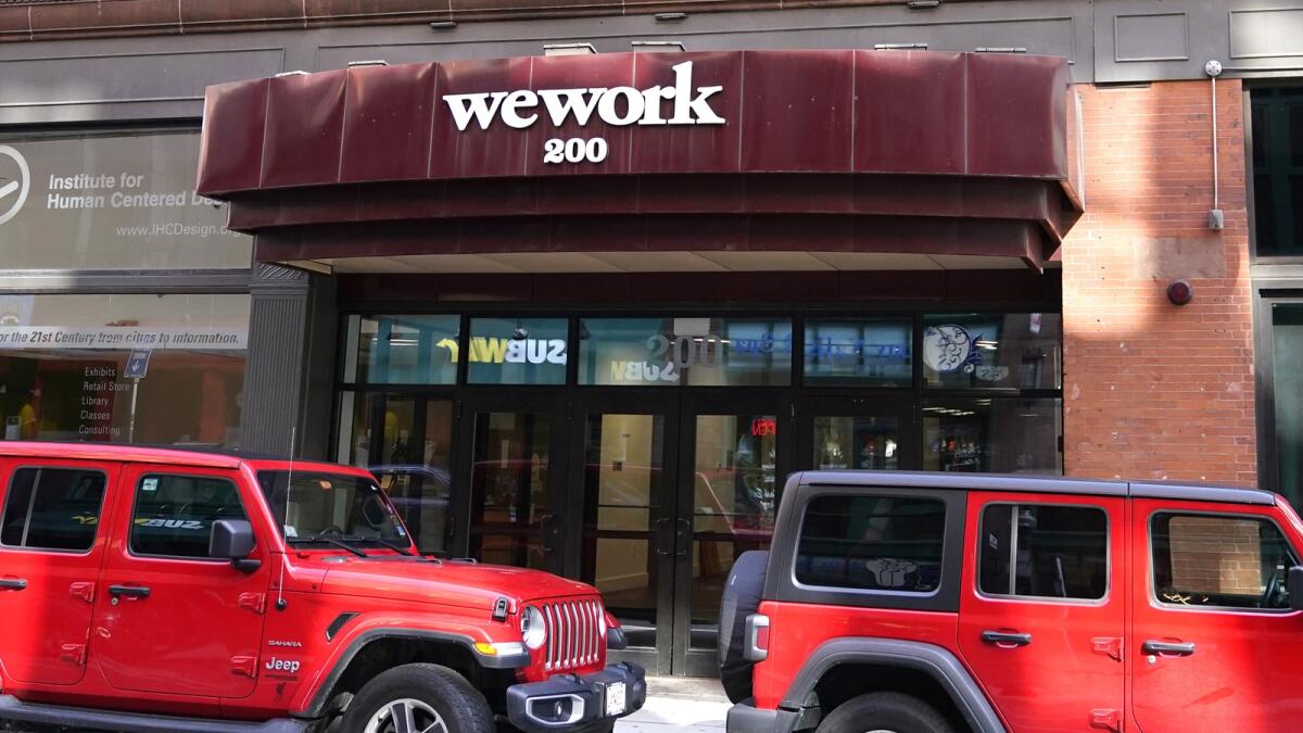 The WeWork logo on a building in Boston. — AP file