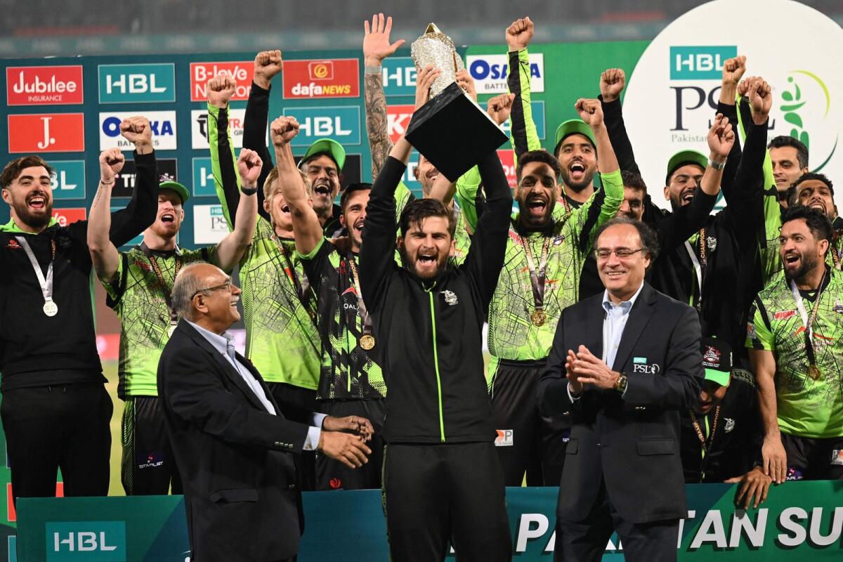 Lahore Qalandars' captain Shaheen Shah Afridi (centre) celebrates with the trophy. — AFP