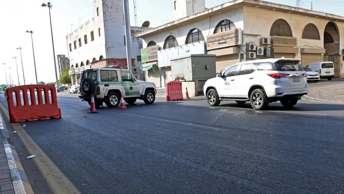 Saudi police close a street leading to a non-Muslim cemetery in the Saudi city of Jeddah where a bomb struck a World War I commemoration attended by European diplomats on November 11, 2020.