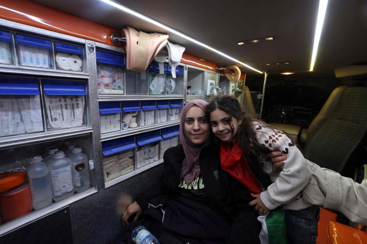 Unable to walk, Fatima Shaheen hugs her daughter Aylool as she sits inside an ambulance after her release from an Israeli prison. AFP