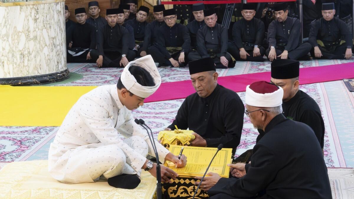 Prince Abdul Mateen signs documents after the solemnization of his wedding at Sultan Omar Ali Saifuddien Mosque in Bandar Seri Begawan, Brunei. — AP