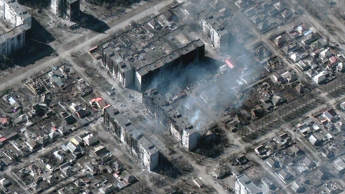 This Maxar satellite image taken and released on March 22, 2022 shows burning and destroyed high-rise apartment buildings in Mariupol, Ukraine. Photo: AFP
