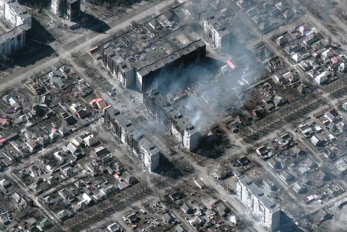 This Maxar satellite image taken and released on March 22, 2022 shows burning and destroyed high-rise apartment buildings in Mariupol, Ukraine. Photo: AFP