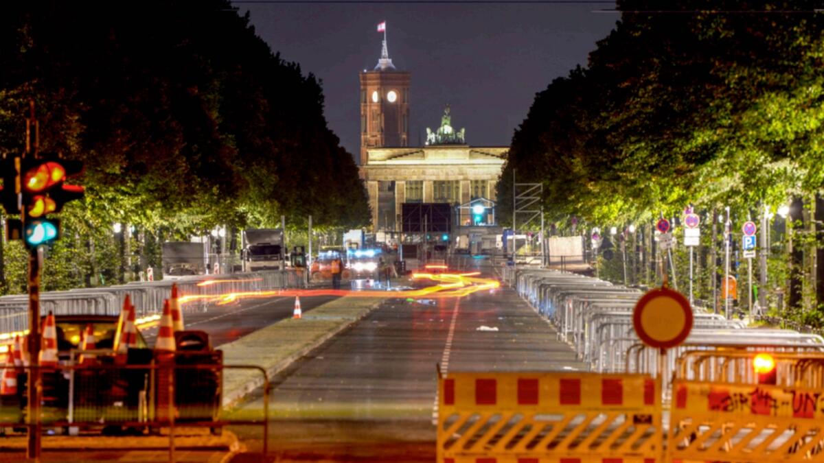 Traffic lights stand at the road leading to the Brandenburg Gate in Berlin, Germany, early Monday, a day after the German elections. — AP