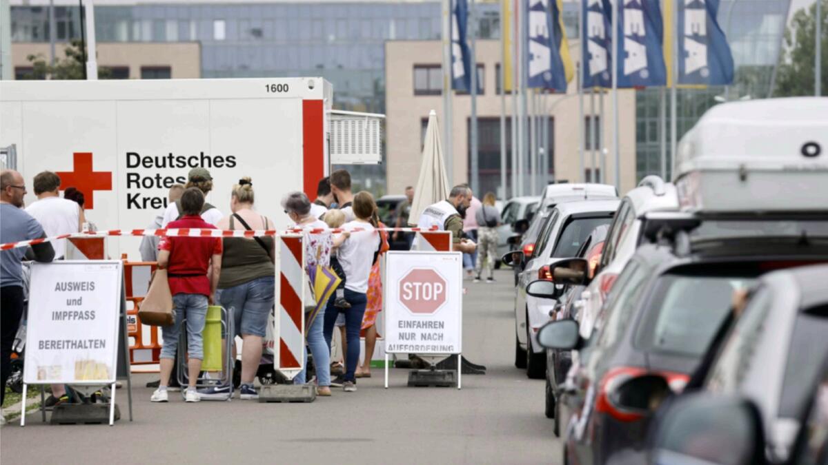 People queue in their cars at a drive-in vaccination centre against the coronavirus disease in Berlin. — Reuters