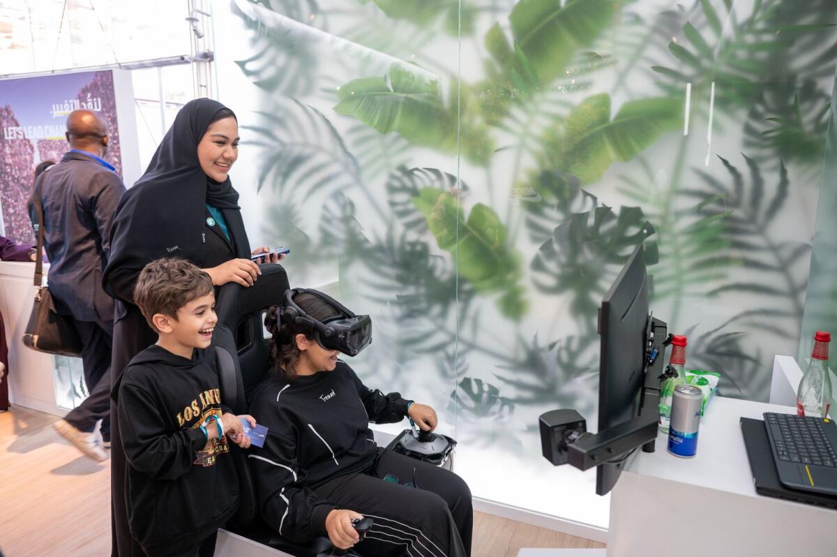 Visitors experience the simulation at RTA stand in COP28. Photo by Shihab