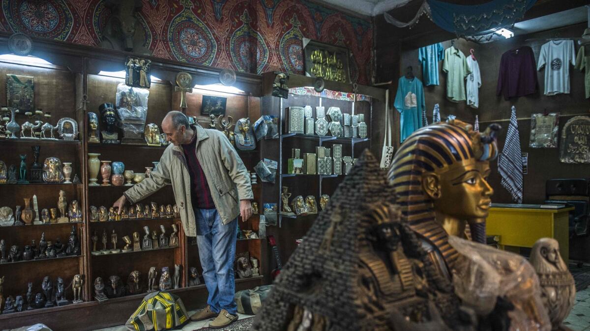 A shop owner waits for customers near the pyramids in the Cairo district of Giza. Security fears in Egypt and Tunisia have hurt the tourism sectors in both countries. 