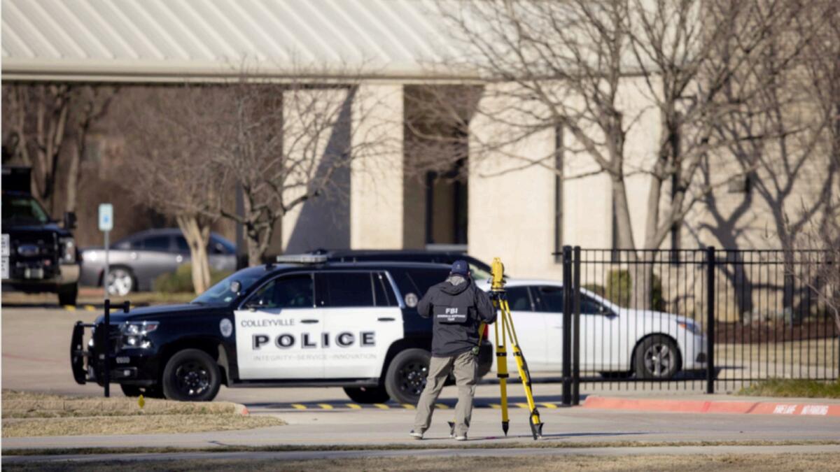 Law enforcement process at the scene in front of the Congregation Beth Israel synagogue in Colleyville, Texas. — AP
