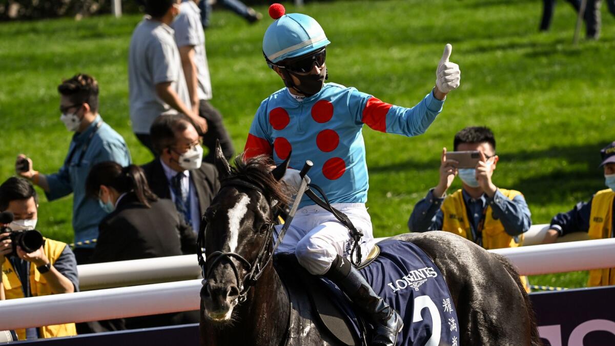 Joao Moreira celebrates after riding Glory Vase to victory in the Hong Kong Vase international horse race on December 12, 2021. (AFP)