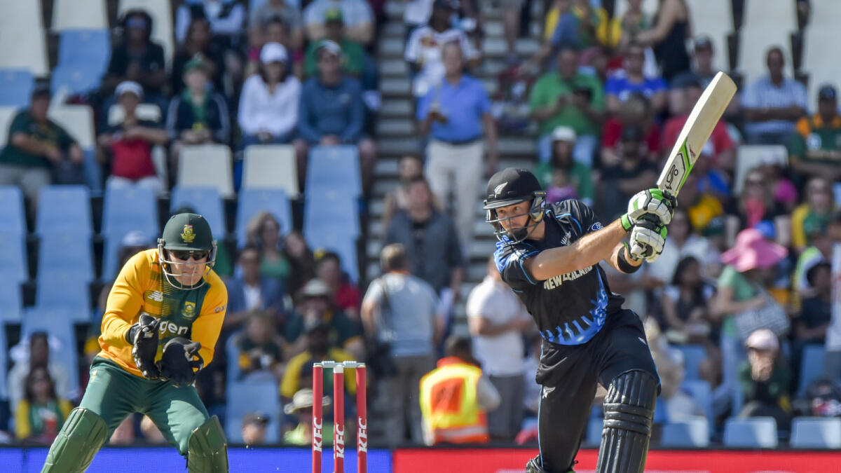 Martin Guptill of New Zealand on his way to scoring 60 as Morne van Wyk of South Africa looks on. 