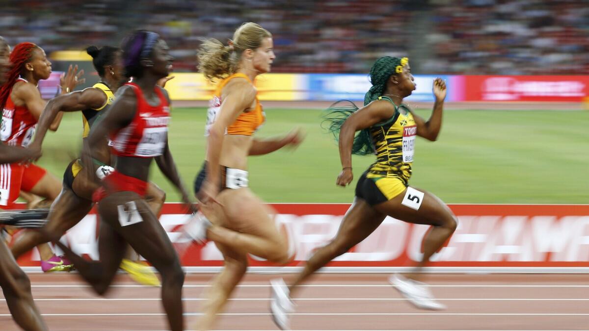 Shelly-Ann Fraser-Pryce of Jamaica (right) on her way to women’s 100 metres win. 