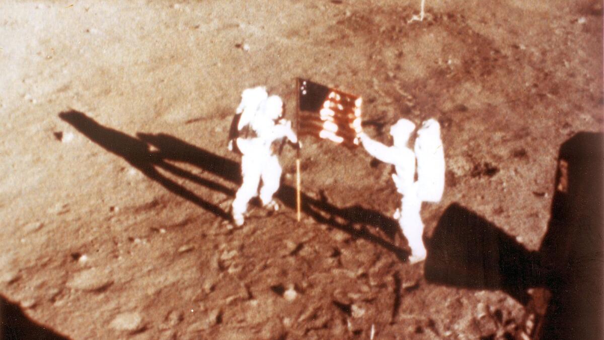 US astronauts Neil Armstrong and 'Buzz' Aldrin deploy the US flag on the lunar surface during the Apollo 11 lunar landing mission.  — AFP file