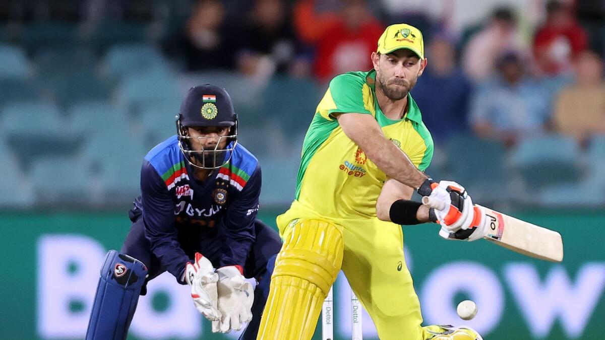 Australia's Glenn Maxwell plays a switch hit as India's wicketkeeper KL Rahul looks on.(AFP)
