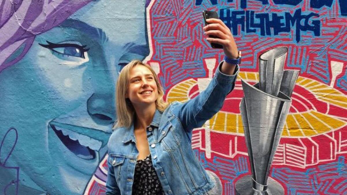 Australia all-rounder Ellyse Perry, the ICC Women's Cricketer of the Year, poses for a selfie in front of a mural promoting the Women's T20 World Cup tournament in Melbourne's Hosier Lane, Australia, February 6, 2020. (Reuters file)