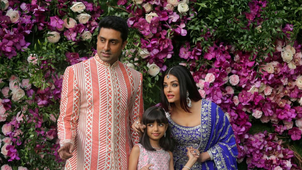 Actor Abhishek Bachchan, his wife actress Aishwarya Rai and their daughter Aaradhya pose during a photo opportunity at a wedding ceremony at Bandra-Kurla Complex in Mumbai. — Reuters file