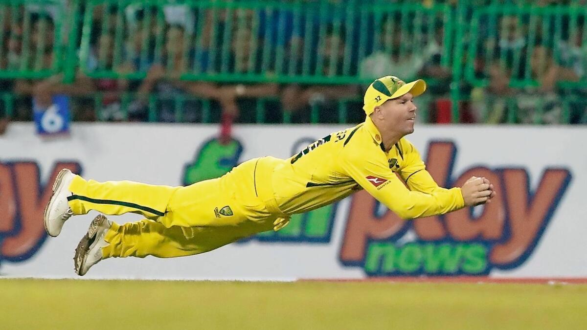 Australia's David Warner takes a brilliant catch to dismiss Sri Lanka's Dushmantha Chameera during the first Twenty20 in Colombo on Tuesday.— AP