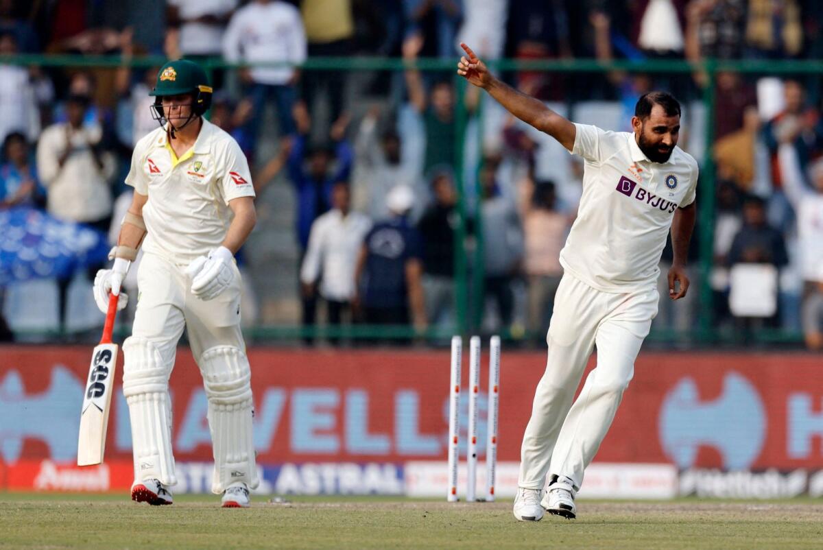 India's Mohammed Shami (right) celebrates after taking the wicket of Australian debutant Matthew Kuhnemann. — Reuters