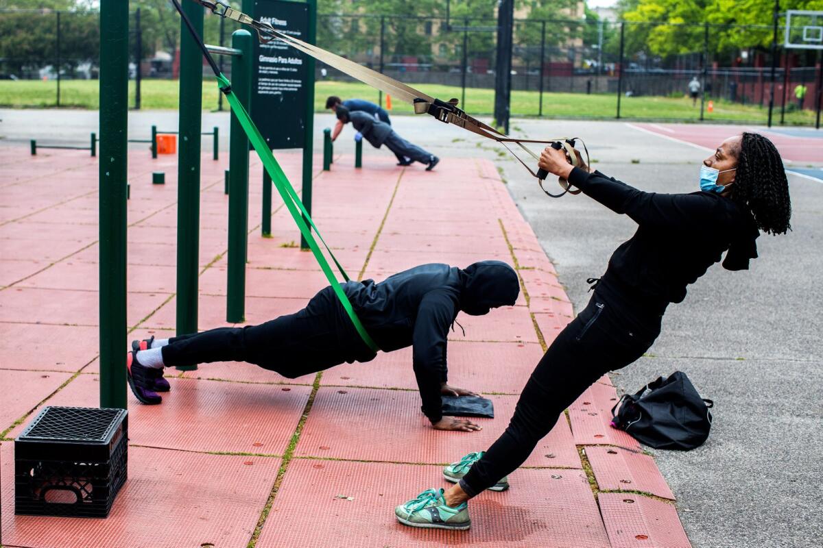 People work out at a park in Brooklyn, May 23, 2020. — Demetrius Freeman/The New York Times