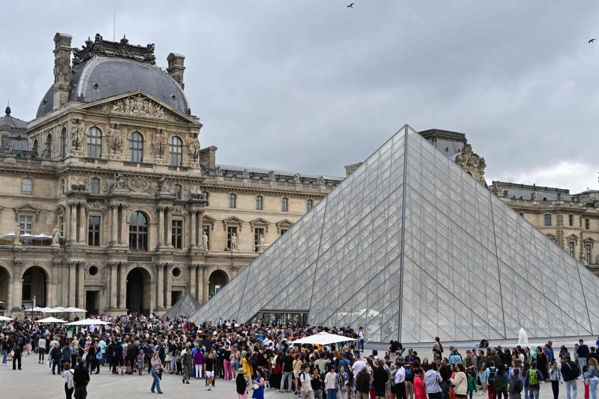 Visitors queue to enter the Louvre museum in Paris on Wednesday. — AFP
