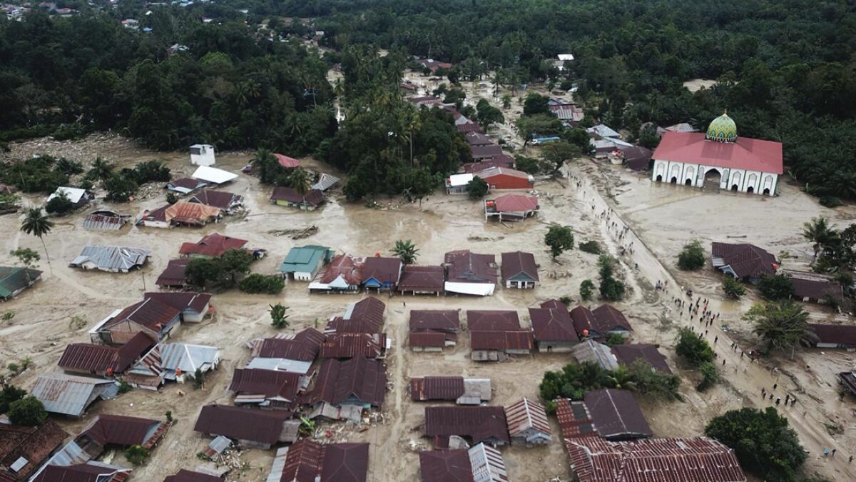 This aerial photo taken using a drone shows an area affected by flash floods in Luwu Utara, South Sulawesi province, Indonesia. A number of people were killed and missing after heavy rains in South Sulawesi province swelled rivers and sent flood waters, mud and debris across roads and into thousands of homes. Photo: AP