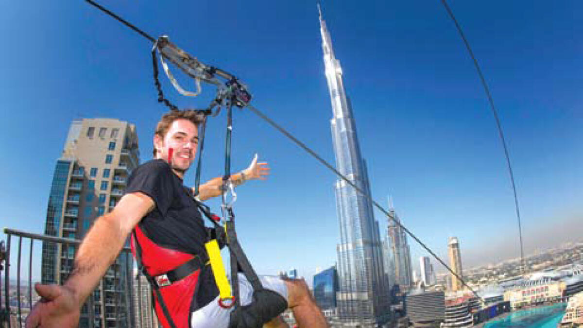 Swiss tennis star Wawrinka ziplines over the Dubai Fountain in Downtown Dubai