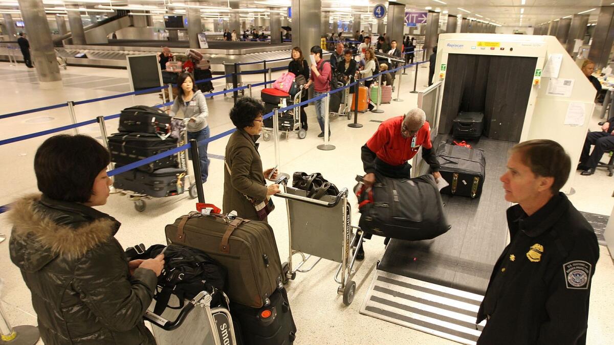 Travellers have their baggage x-rayed by US Customs and Border Protection agents upon arrival at Los Angeles International Airport. Photo: AFP