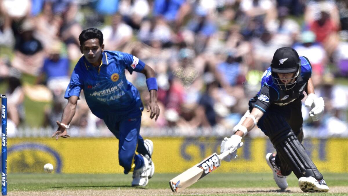Chamara Kapugedera (L) of Sri Lanka runs out Mitchell Santner of New Zealand during the 3rd One Day International cricket match between New Zealand and Sri Lanka at Saxton Oval in Nelson on December 31, 2015. AFP PHOTO / MARTY MELVILLE