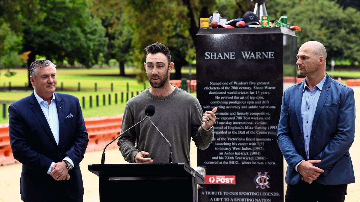 Remembering a legend: Australian cricketer Glenn Maxwell (centre) speaks as former Australian Rules footballer Aaron Hamill (right) and media personality Eddie McGuire look on during a press conference in front of a statue of Shane Warne in Melbourne on Tuesday. — AFP