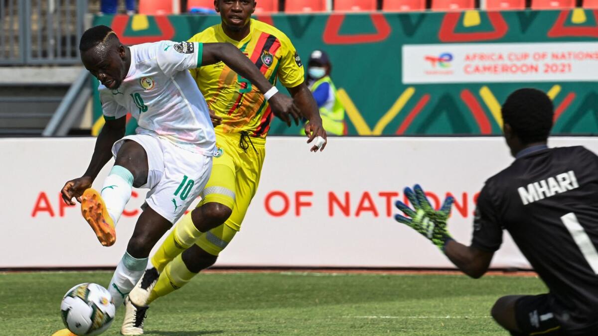 Senegal forward Sadio Mane (left) attempts a shot at goal. (AFP)