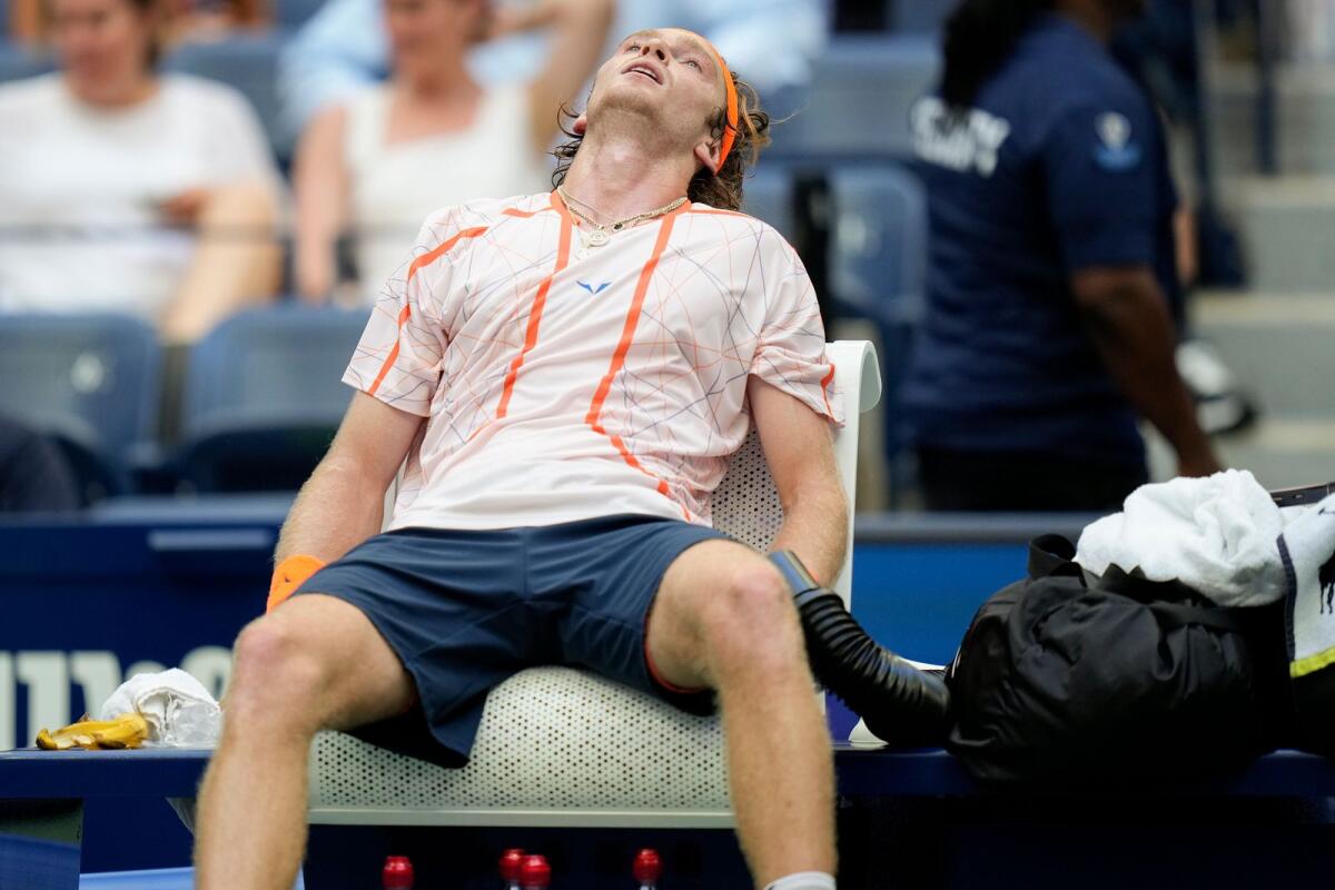 An exhausted Andrey Rublev takes a break between games. — AP