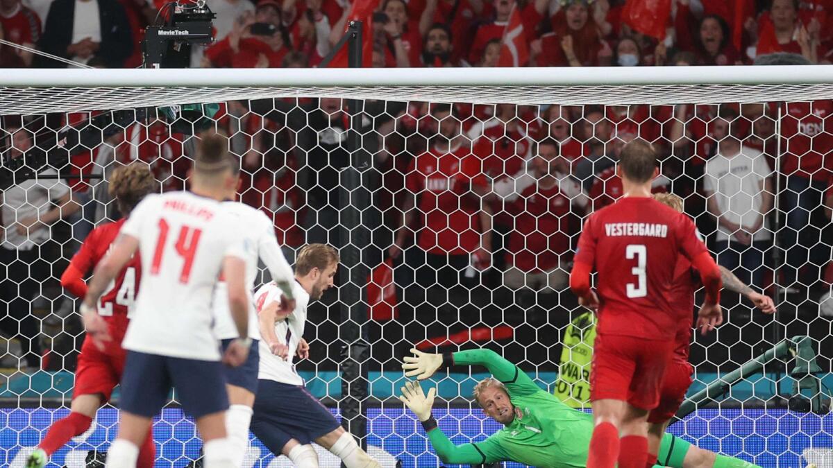 England's forward Harry Kane (centre) scores a goal past Denmark's goalkeeper Kasper Schmeichel during the Euro 2020 semifinal. — AFP