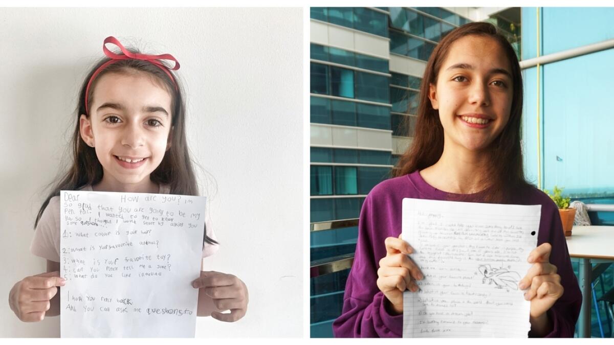WRITE WAY: (left to right) Seven-year-old Poppy and pen pal Lucie hold up samples of their letters