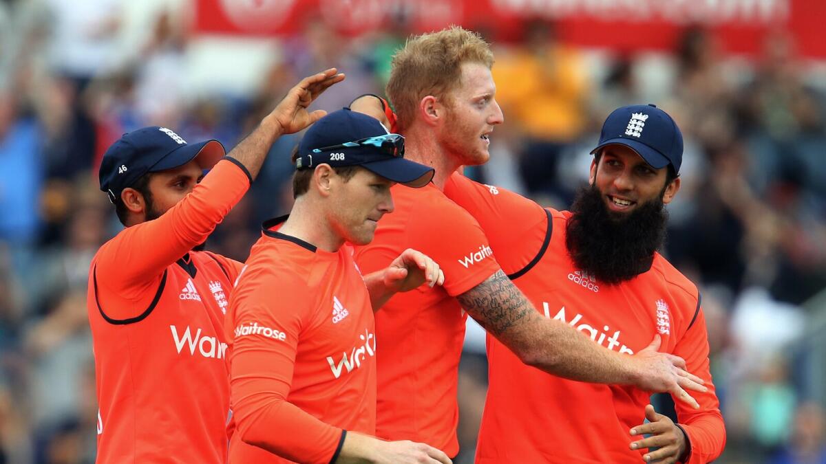 England’s Adil Rashid (left), Eoin Morgan and Moeen Ali (right) congratulate Ben Stokes after their win. 
