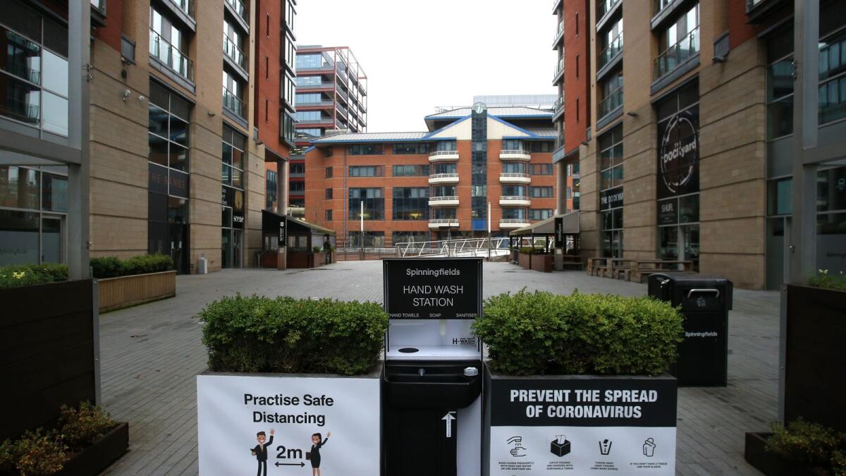 A hand wash station, with advice on keeping socially distanced and other information to prevent the spread of covid-19 is seen in central Manchester, north-west England on November 5, 2020.