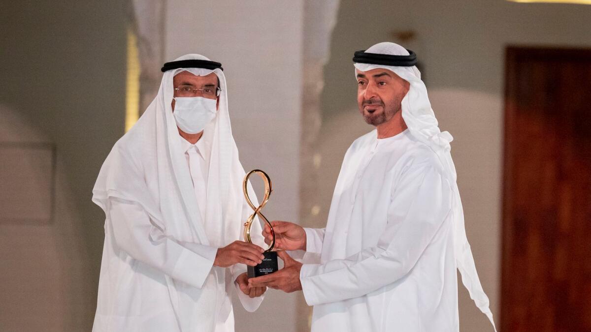 Sheikh Mohamed presents an award to Mohamed Al Murr.