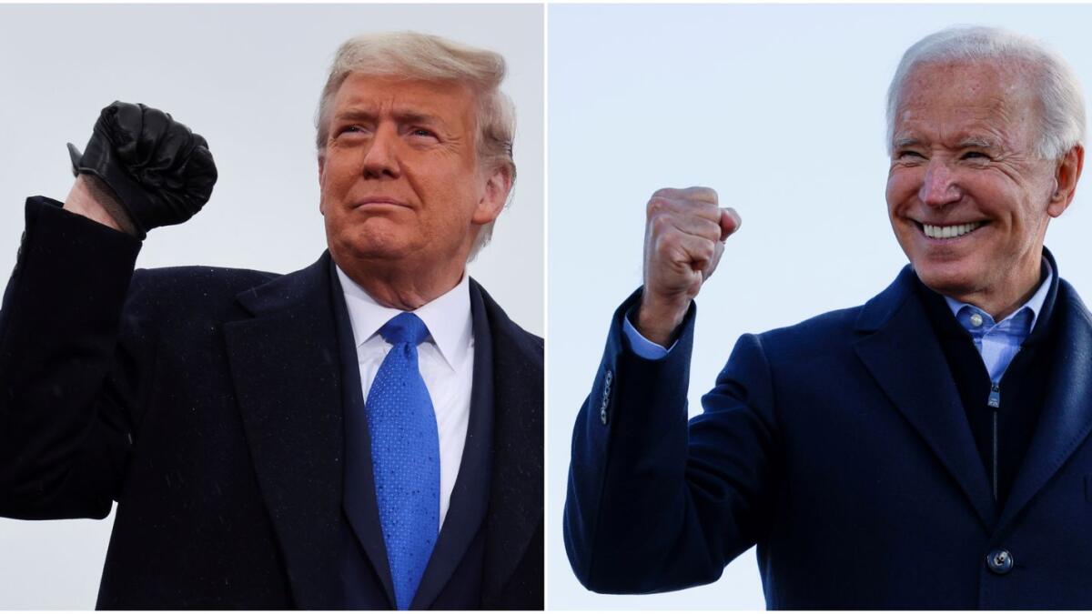 A combination picture shows U.S. President Donald Trump pumping his fist during a campaign event at Capital Region International Airport in Lansing, Michigan, U.S. October 27, 2020, and Democratic U.S. presidential nominee and former Vice President Joe Biden making a fist during a drive-in campaign stop in Des Moines, Iowa, U.S., October 30, 2020. REUTERS/Jonathan Ernst/Brian Snyder/File Photos