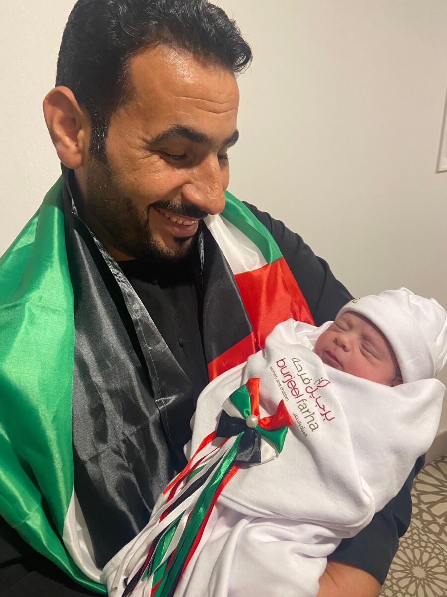 Father Yousif Ali Al Hussain and baby Emarat