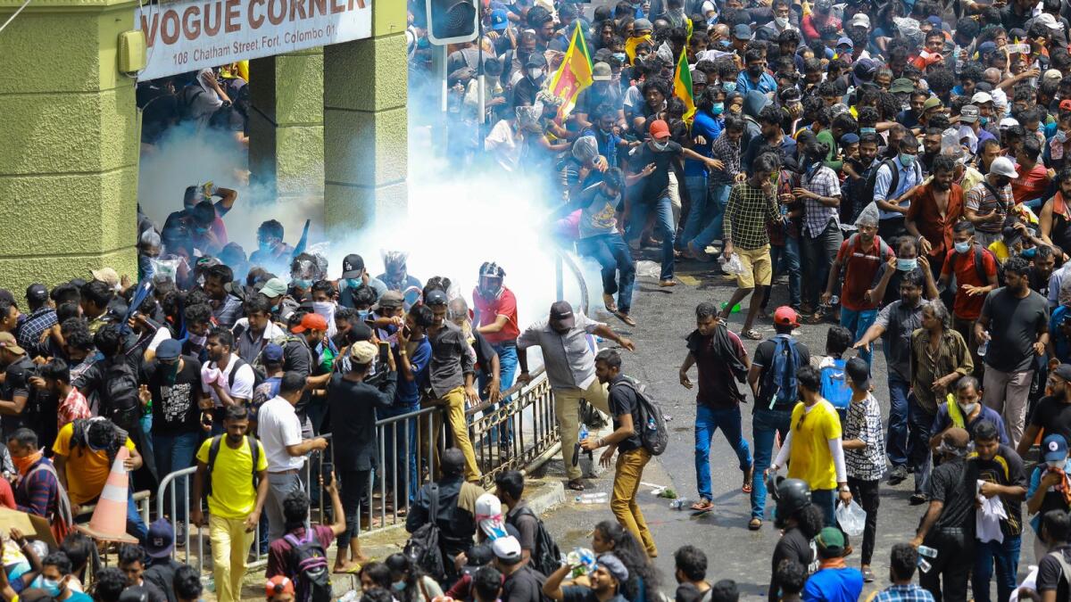 Police fire tear gas canisters to disperse protesters demanding the resignation of Sri Lanka's President Gotabaya in a street leading to Sri Lanka's Presidential Palace in Colombo on July 9, 2022. Photo: AFP