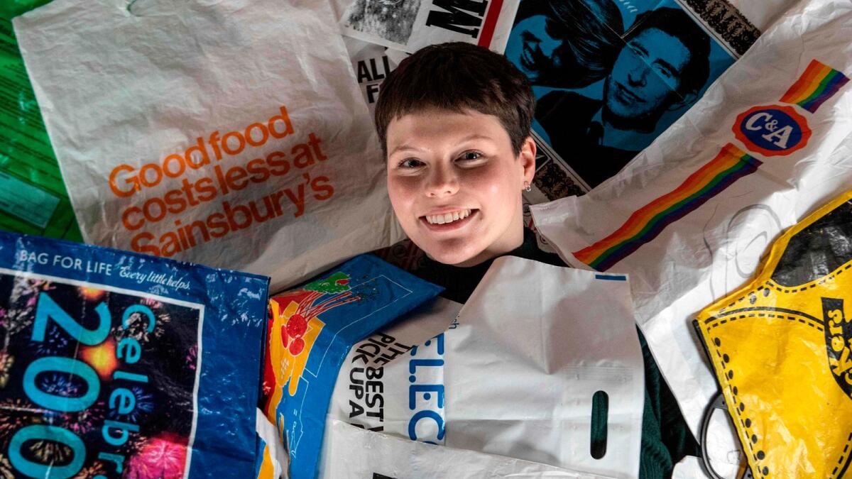 British artist Katrina Cobain poses for photographs with some of her collection of plastic bags from which she intends to start The Plastic Bag Museum in Glasgow.