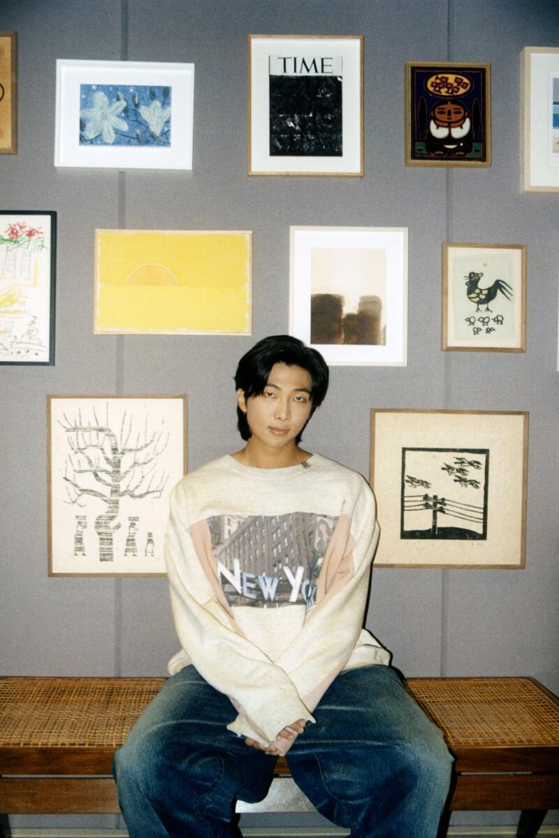 RM, the leader of the South Korean pop group BTS, at his recording studio in Seoul with an art collection including works by Park Soo Keun, Ugo Rondinone, Yun Hyong-keun and Chang Ucchin on Aug. 18, 2022. (Dasom Han/The New York Times)