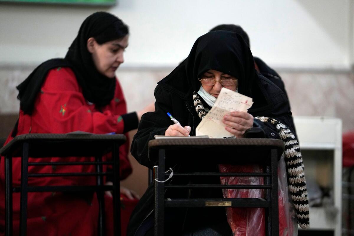 Voters fill out their ballots during the parliamentary and Assembly of Experts elections at a polling station in Tehran, Iran, on March 1, 2024.— AP file photo used for illustrative purpose only