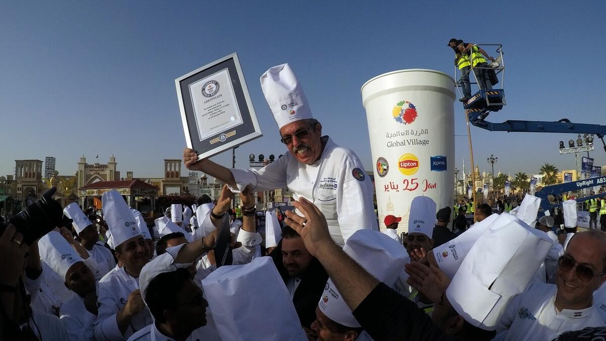 Chef Uwe Micheel of Radisson Blu and other chefs celebrate winning the Guinness Book World Record for the largest cup of the Hot Tea, Kadak tea at Global Village.-Photo by Shihab