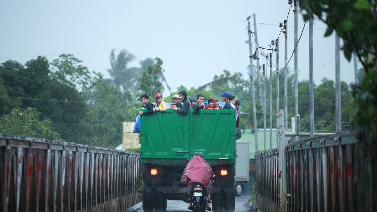 Residents ride on the back of a truck as they are evacuated to a temporary shelter due to Mayon volcano's eruption in Camalig town, Manila.  AFP
